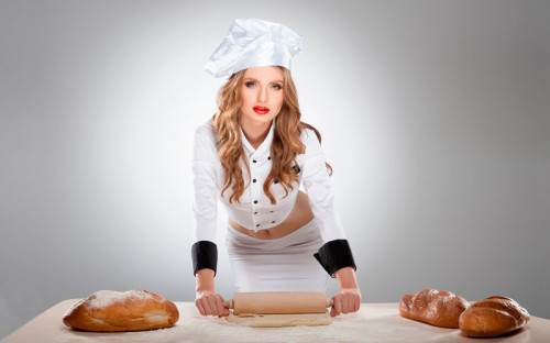 Красивая девушка кондитер готовит тесто для хлеба